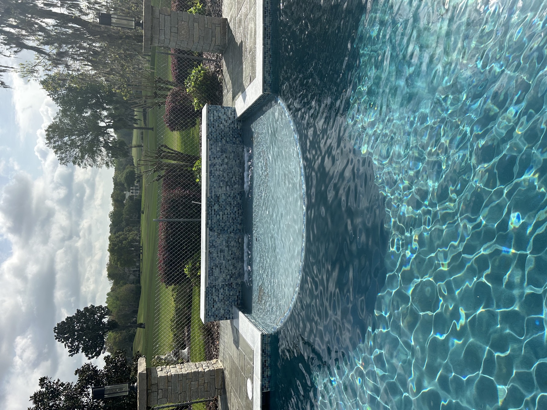 Finished Koah pool with sun shelf and tiled water wall